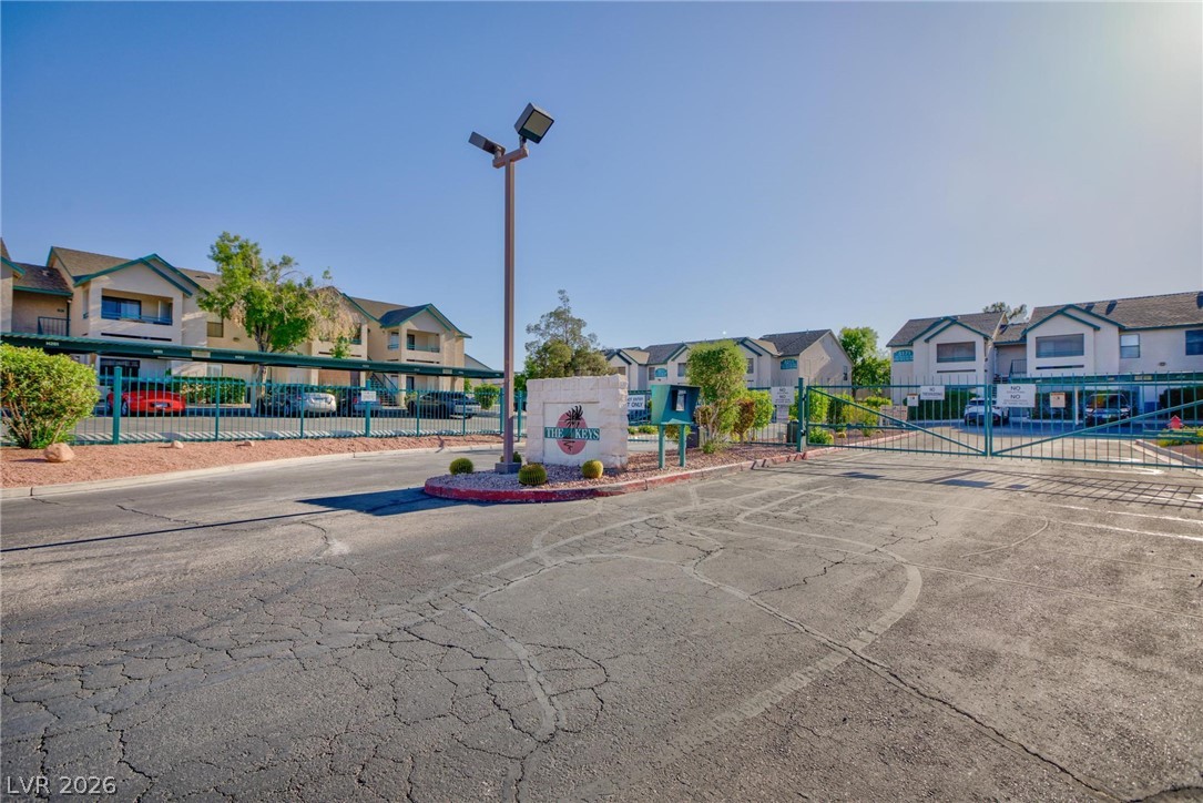 5171 South Lindell Road, Unit 103 Las Vegas, NV 89118 - Photo 20 of 24 Secure community entrance with an inviting sign and practical resident parking solutions.