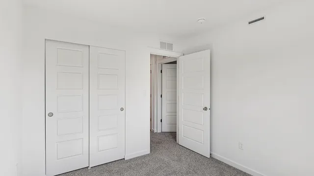 an empty room with closet area