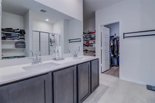 a kitchen with stainless steel appliances a sink and a refrigerator