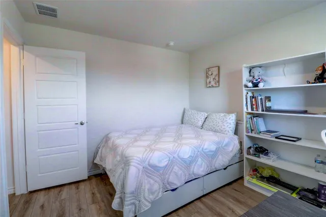a bedroom with a bed and a book shelf
