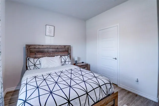 a bedroom with a bed and a night stand