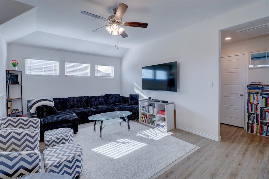 7404 Seton Place McKinney, TX 75071 - Photo 21 of 29 a living room with furniture and a flat screen tv