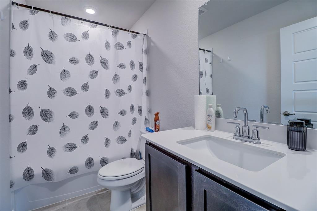 7404 Seton Place McKinney, TX 75071 - Photo 26 of 29 a bathroom with a sink and a mirror