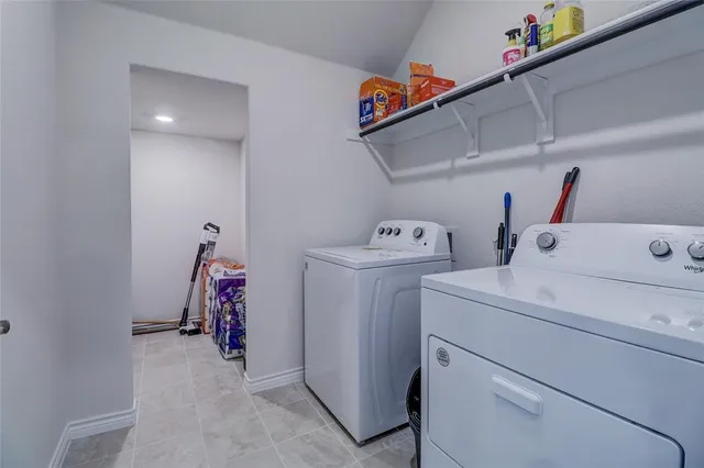 a view of storage and utility room with washer and dryer
