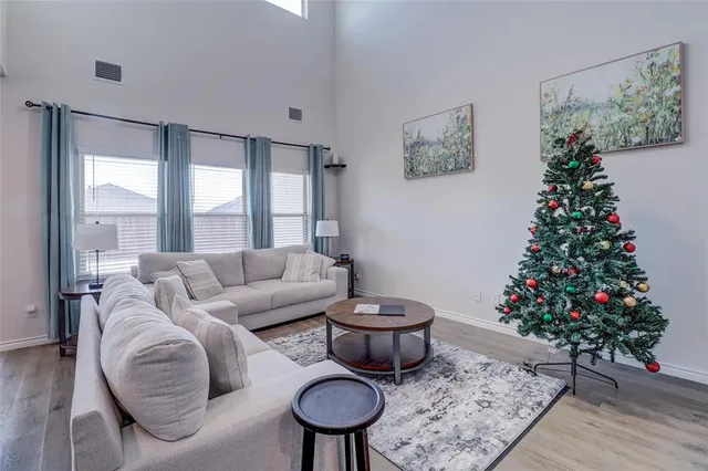 a living room with furniture and a potted plant