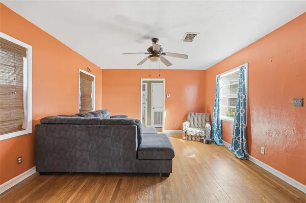 a living room with furniture and large windows