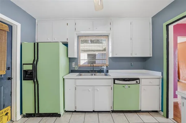 a kitchen with a refrigerator and a stove top oven