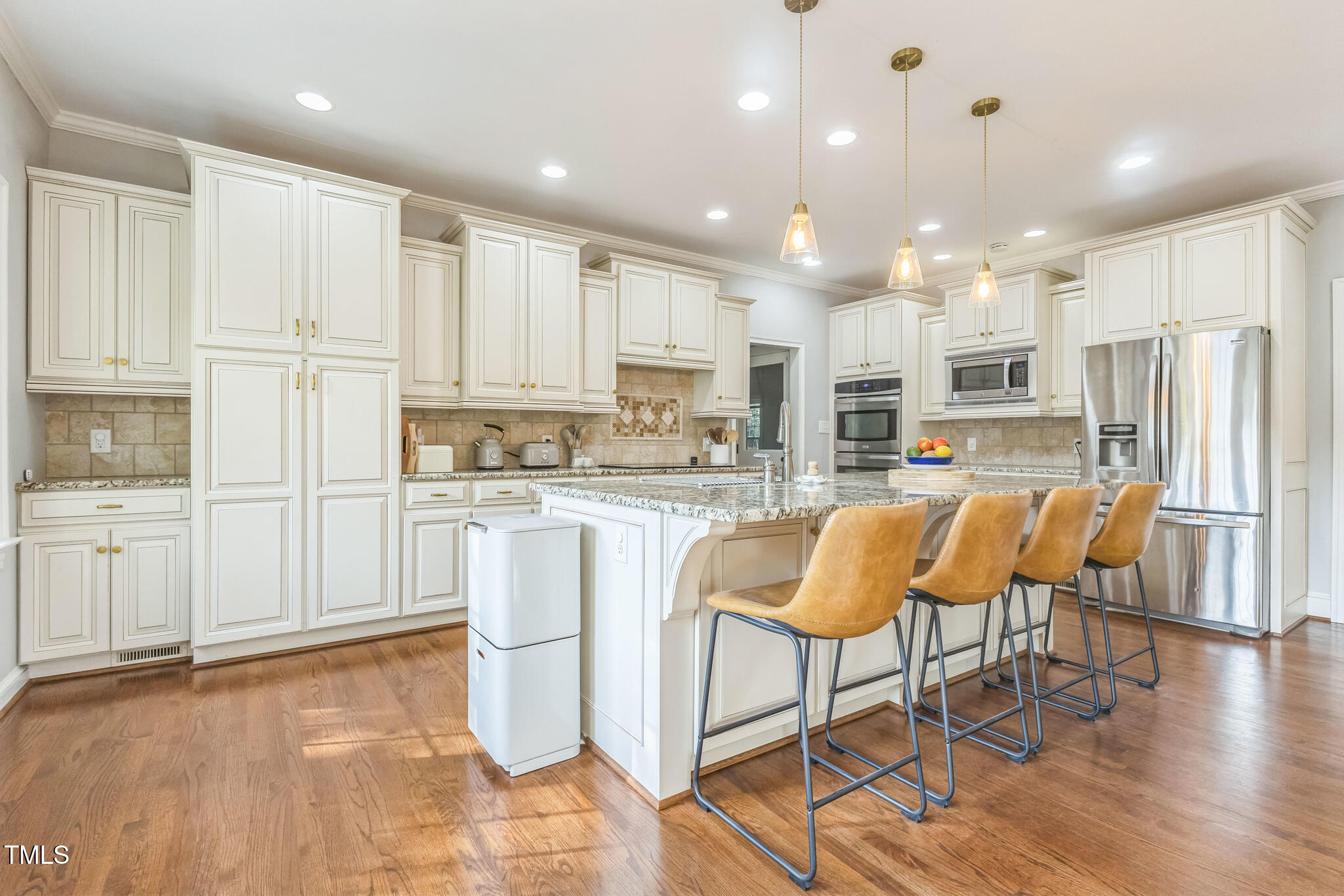 1708 Pendelton Drive Raleigh, NC 27614 - Photo 12 of 54 a kitchen with stainless steel appliances granite countertop a stove a sink a refrigerator and white cabinets with wooden floor