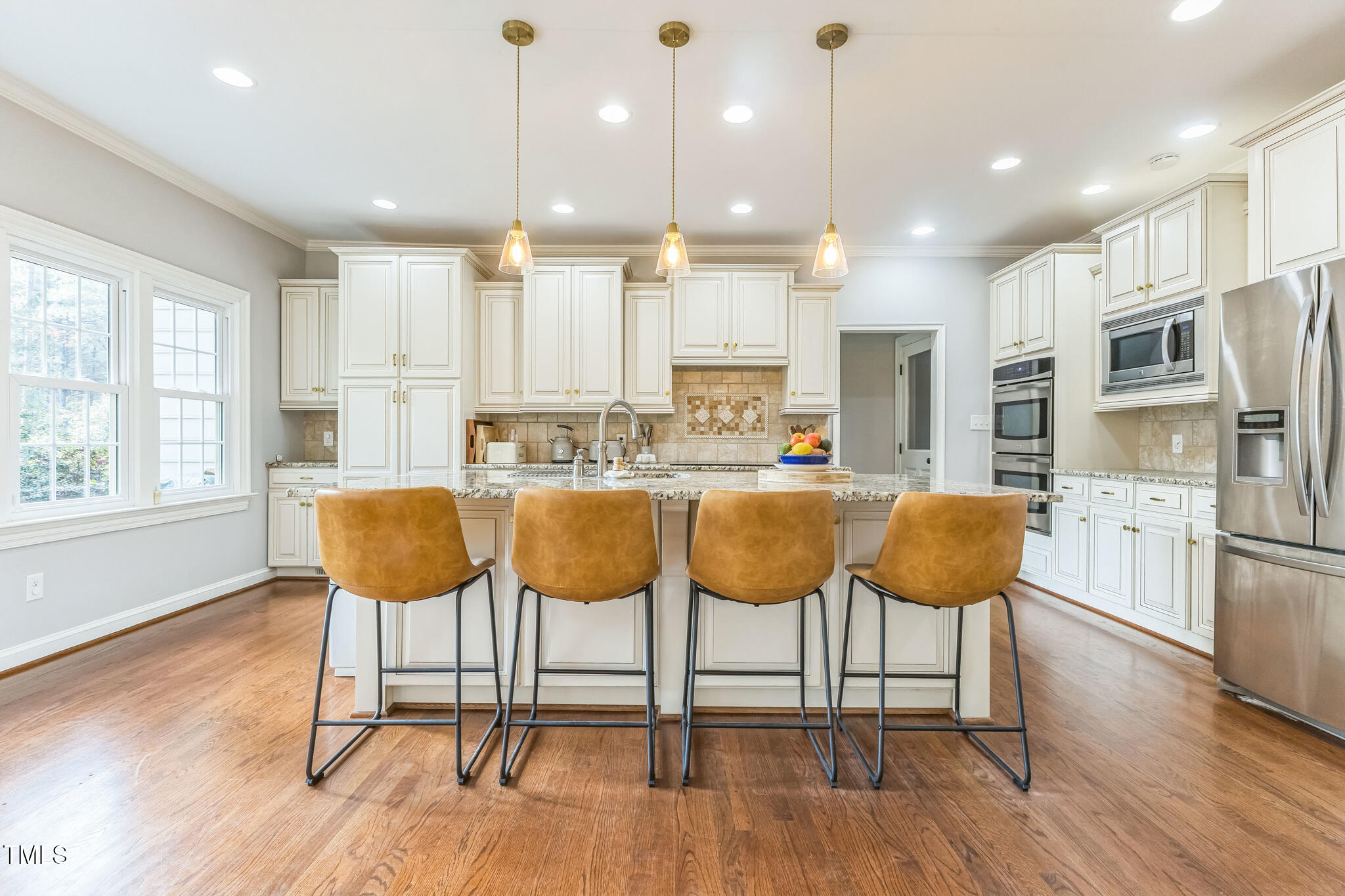 1708 Pendelton Drive Raleigh, NC 27614 - Photo 16 of 54 a large kitchen with a table and chairs