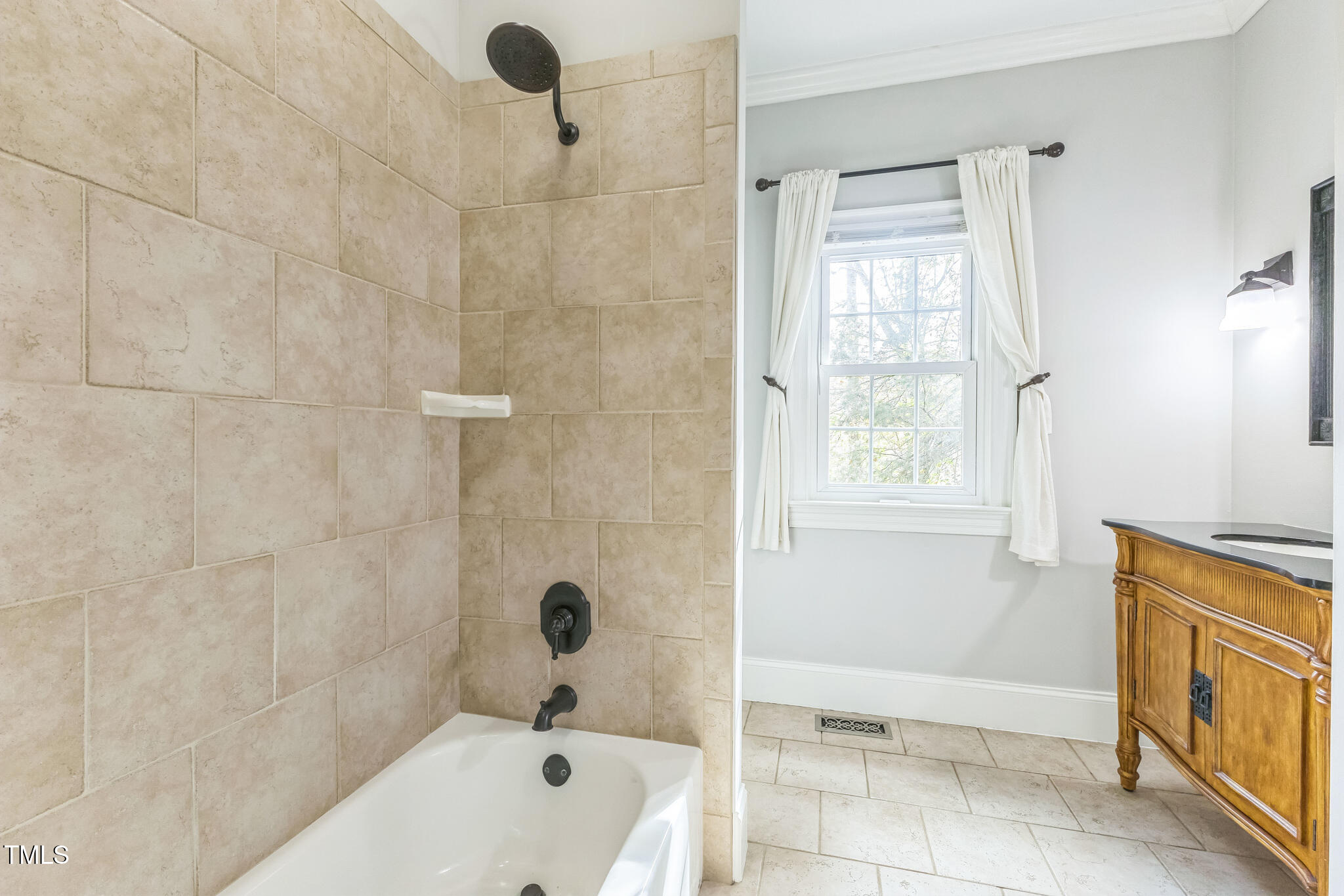 1708 Pendelton Drive Raleigh, NC 27614 - Photo 38 of 54 a bathroom with a tub a sink and a shower