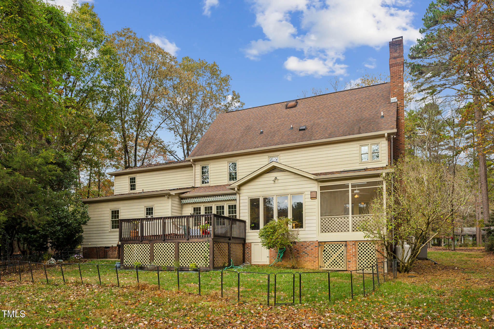 1708 Pendelton Drive Raleigh, NC 27614 - Photo 45 of 54 a view of a large white house with large windows and a yard with plants and large trees