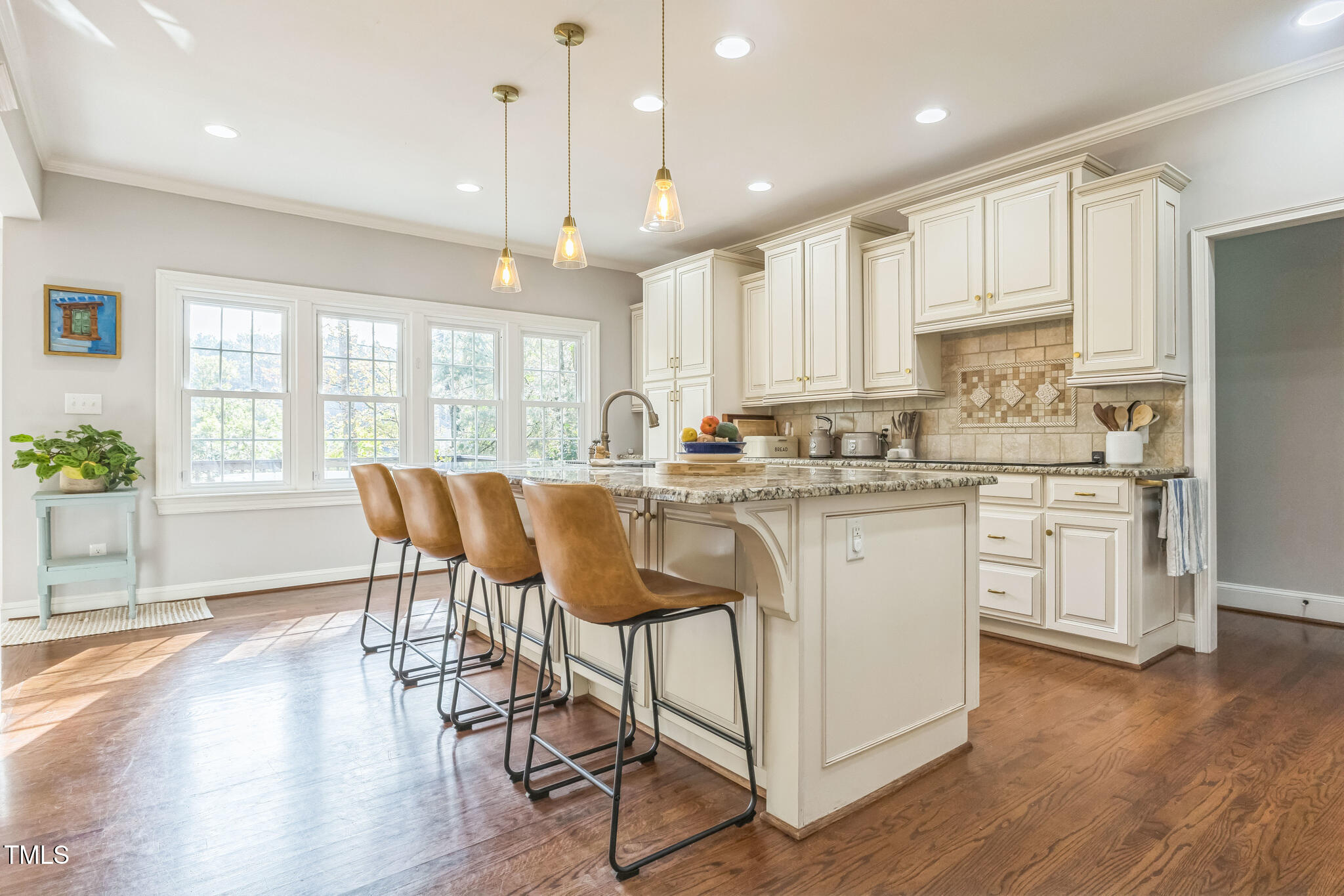 1708 Pendelton Drive Raleigh, NC 27614 - Photo 10 of 54 a kitchen with stainless steel appliances granite countertop a stove a sink a refrigerator with white cabinets and wooden floor