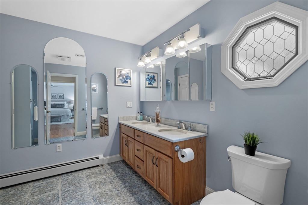512 A Main Street Boxford, MA 01921 - Photo 18 of 41 a bathroom with a sink a mirror a toilet and a shower