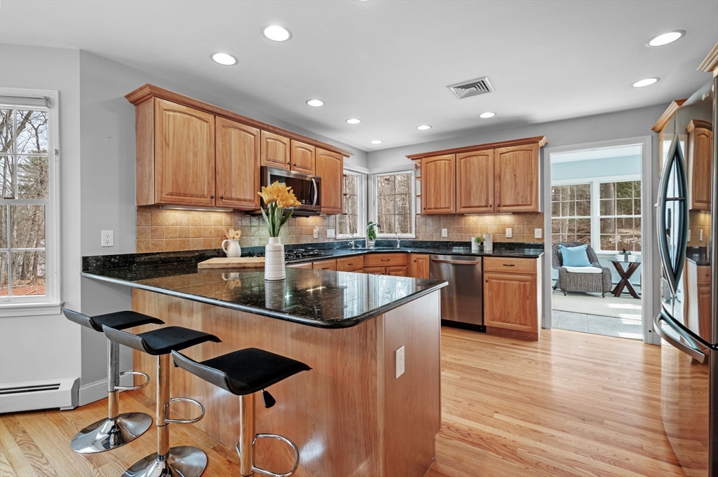 512 A Main Street Boxford, MA 01921 - Photo 6 of 41 a kitchen with stainless steel appliances granite countertop a sink a stove and a refrigerator