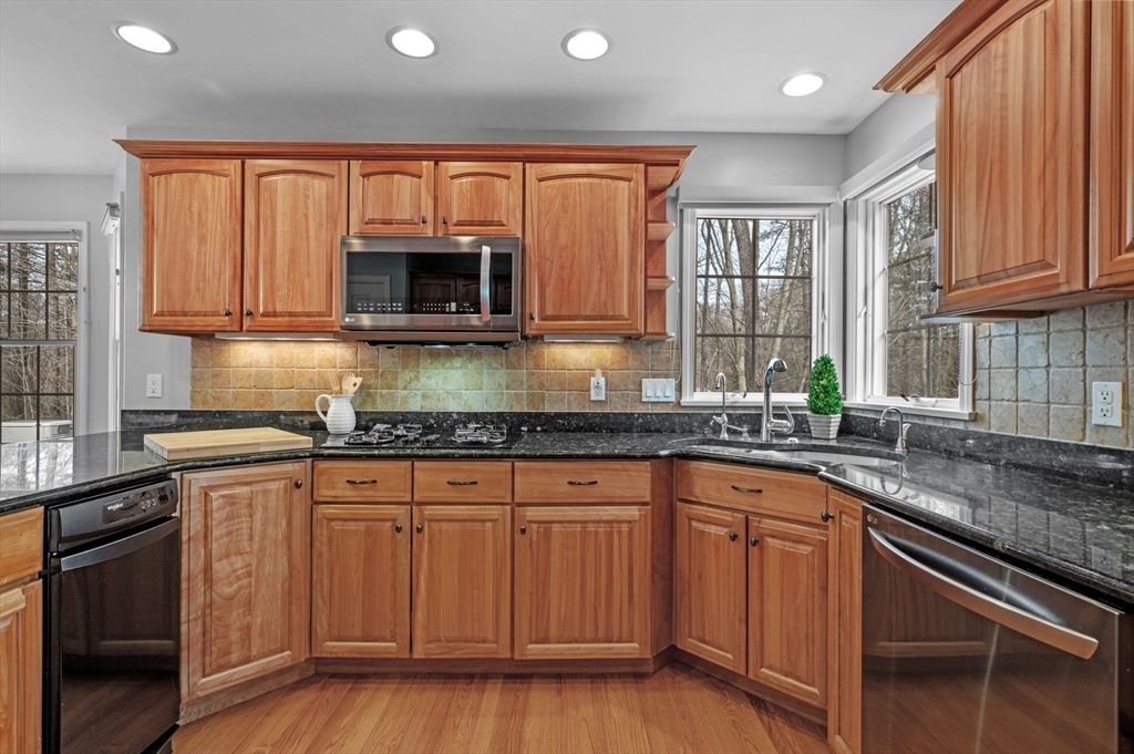 512 A Main Street Boxford, MA 01921 - Photo 8 of 41 a kitchen with granite countertop a sink and wooden cabinets
