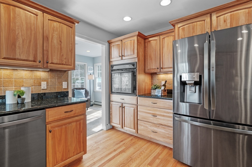 512 A Main Street Boxford, MA 01921 - Photo 9 of 41 a kitchen with granite countertop stainless steel appliances a refrigerator and cabinets
