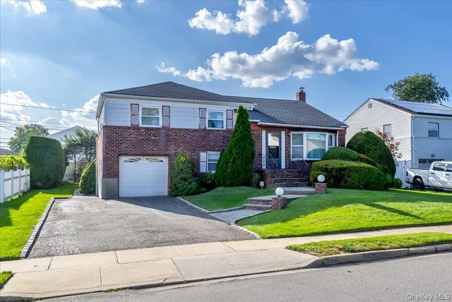 a front view of a house with a yard and garage