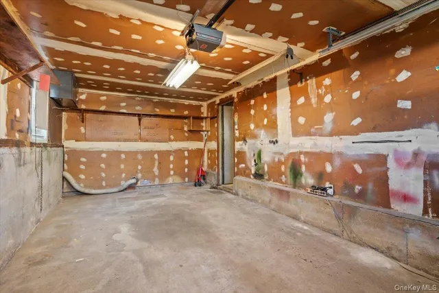 a view of a empty room with a garage
