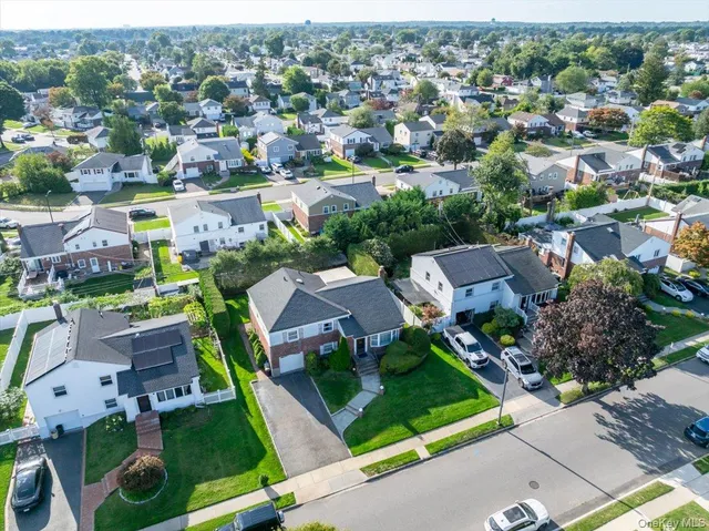 an aerial view of residential houses with outdoor space