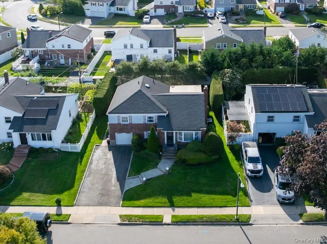 an aerial view of multiple houses with a yard