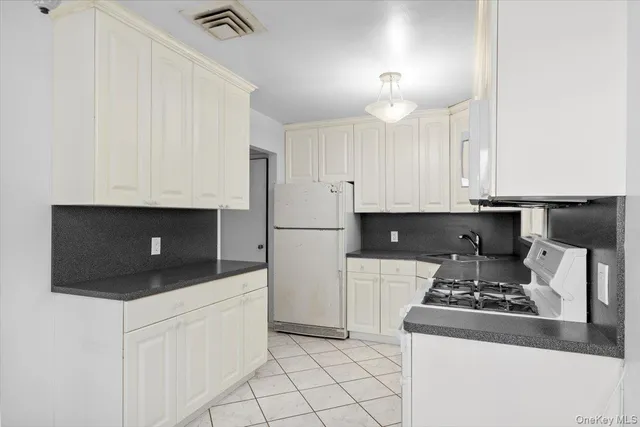 a kitchen with stainless steel appliances a stove a microwave and cabinets