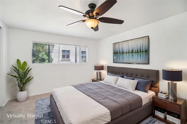 a bedroom with a bed and ceiling fan