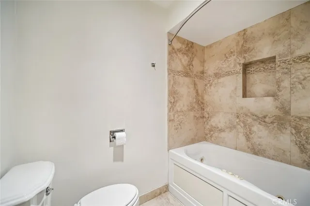 a bathroom with a toilet and a bathtub