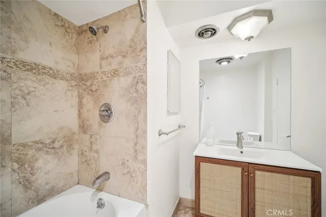 a bathroom with a sink mirror toilet and shower