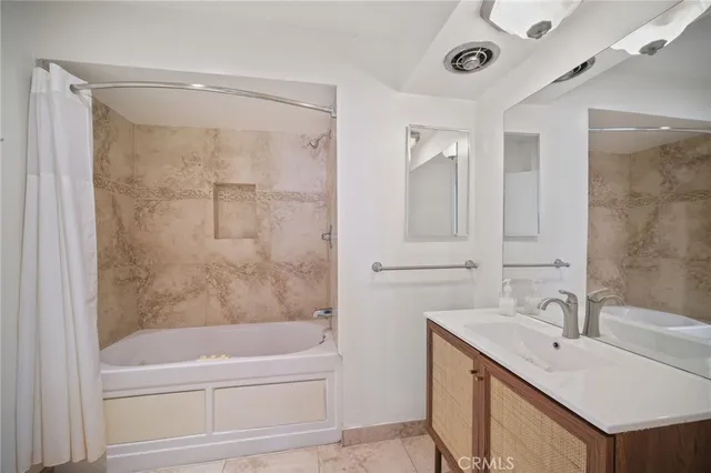 a bathroom with a bathtub shower sink and mirror