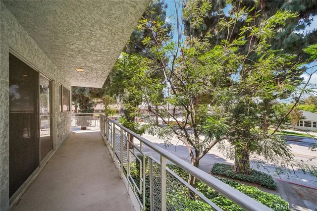 a view of a wooden balcony and trees
