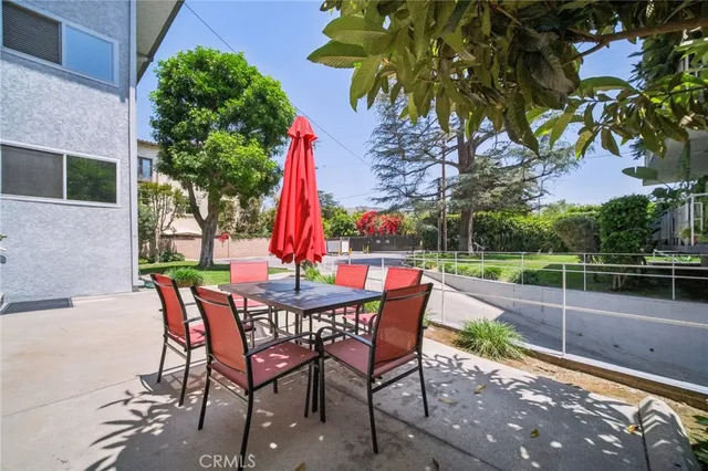 a view of a patio with table and chairs and potted plants