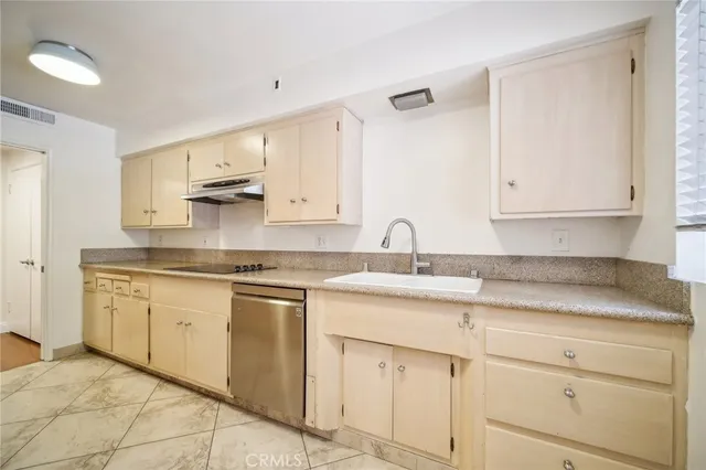 a kitchen with stainless steel appliances granite countertop a sink and cabinets