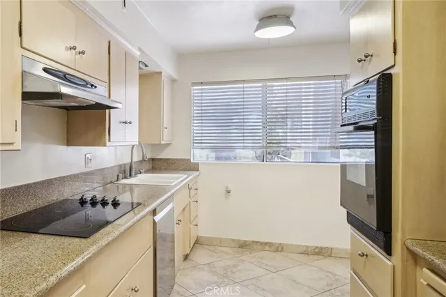 a kitchen with a sink a stove and cabinets