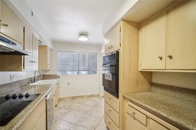 a kitchen with stainless steel appliances granite countertop a sink and a stove