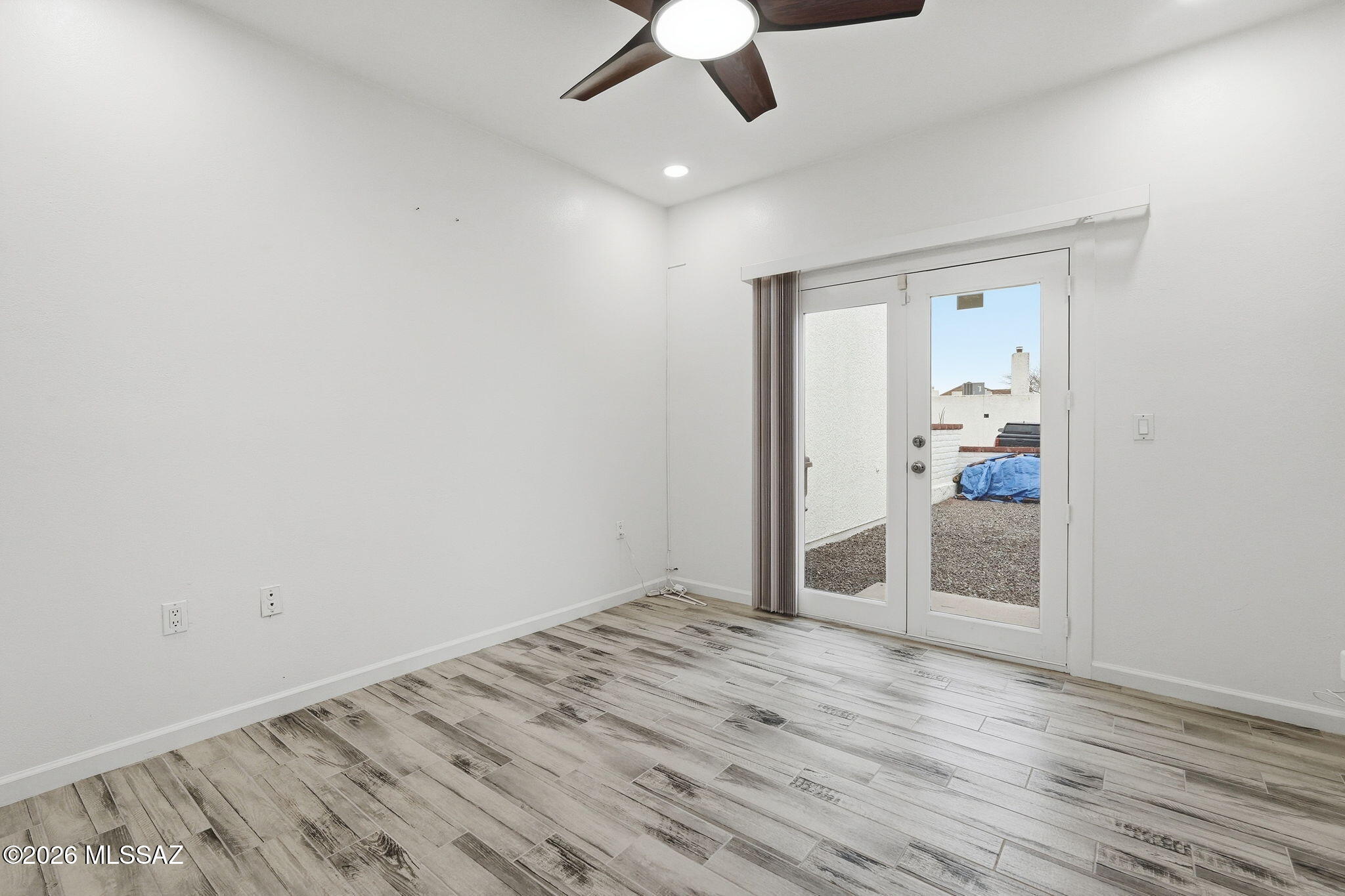 1183 Circulo Canario Rio Rico, AZ 85648 - Photo 19 of 31 an empty room with wooden floor chandelier fan and entryway