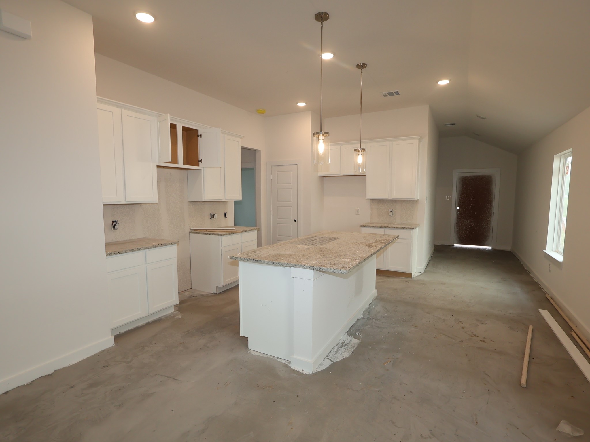 32519 Midsummer Drive Fulshear, TX 77441 - Photo 3 of 15 a large kitchen with kitchen island a white counter space a sink and appliances