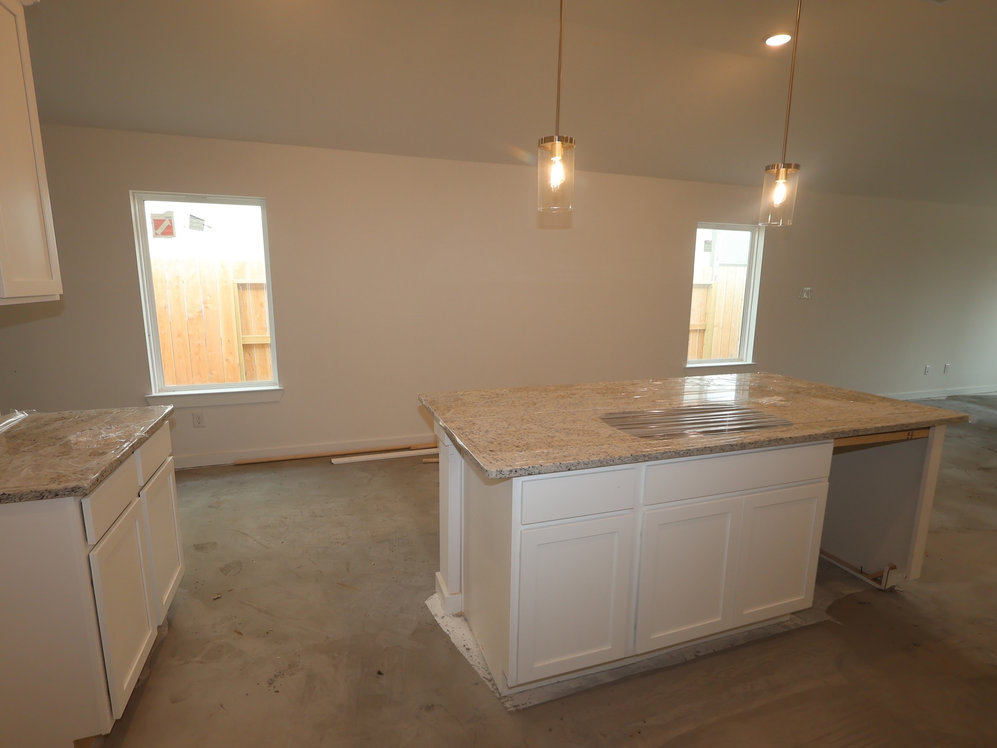 32519 Midsummer Drive Fulshear, TX 77441 - Photo 5 of 15 a view of a kitchen with a sink and dishwasher with wooden floor