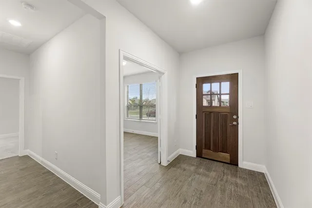 an empty room with windows and entrance