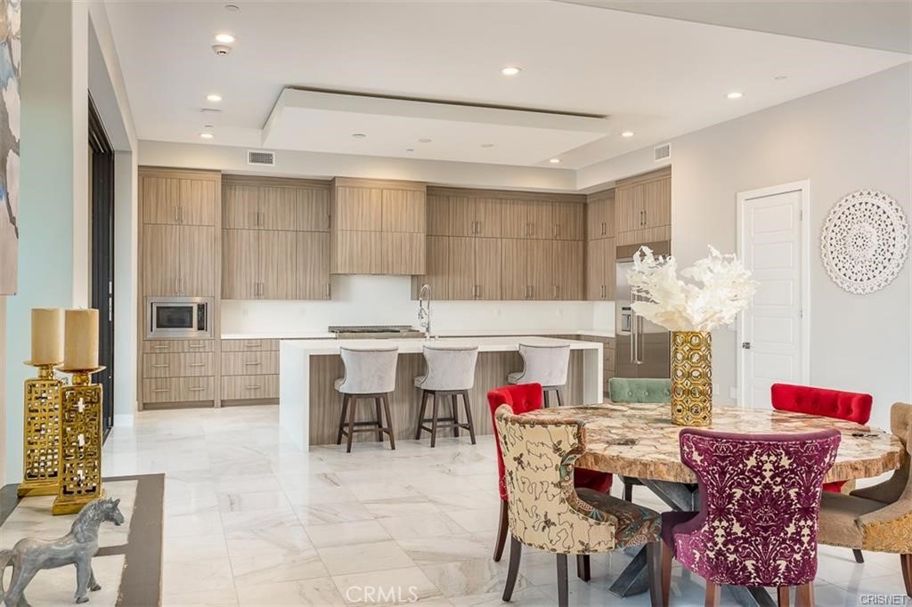 11527 North Darcy Porter Ranch Porter Ranch, CA 91326 - Photo 12 of 32 a dining room with furniture a table and kitchen view