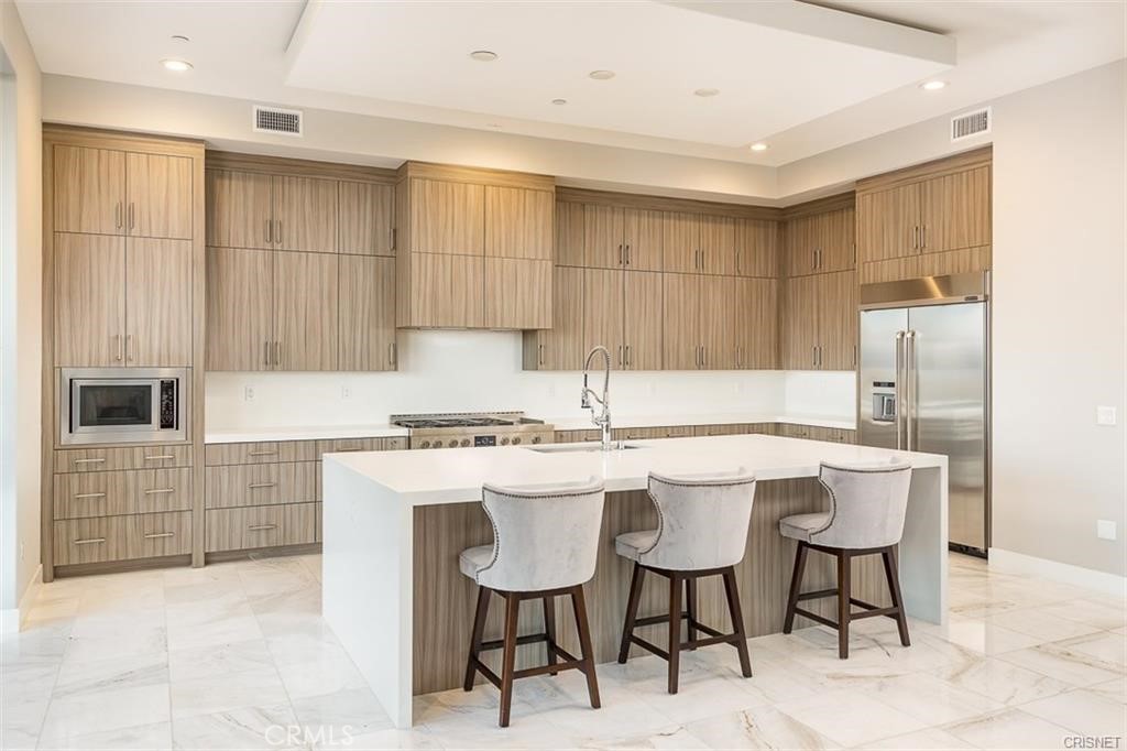 11527 North Darcy Porter Ranch Porter Ranch, CA 91326 - Photo 13 of 32 a kitchen with a table chairs stove and refrigerator