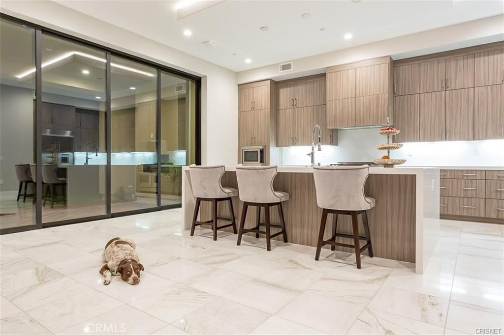 11527 North Darcy Porter Ranch Porter Ranch, CA 91326 - Photo 25 of 32 a dining hall with a sink and a mirror