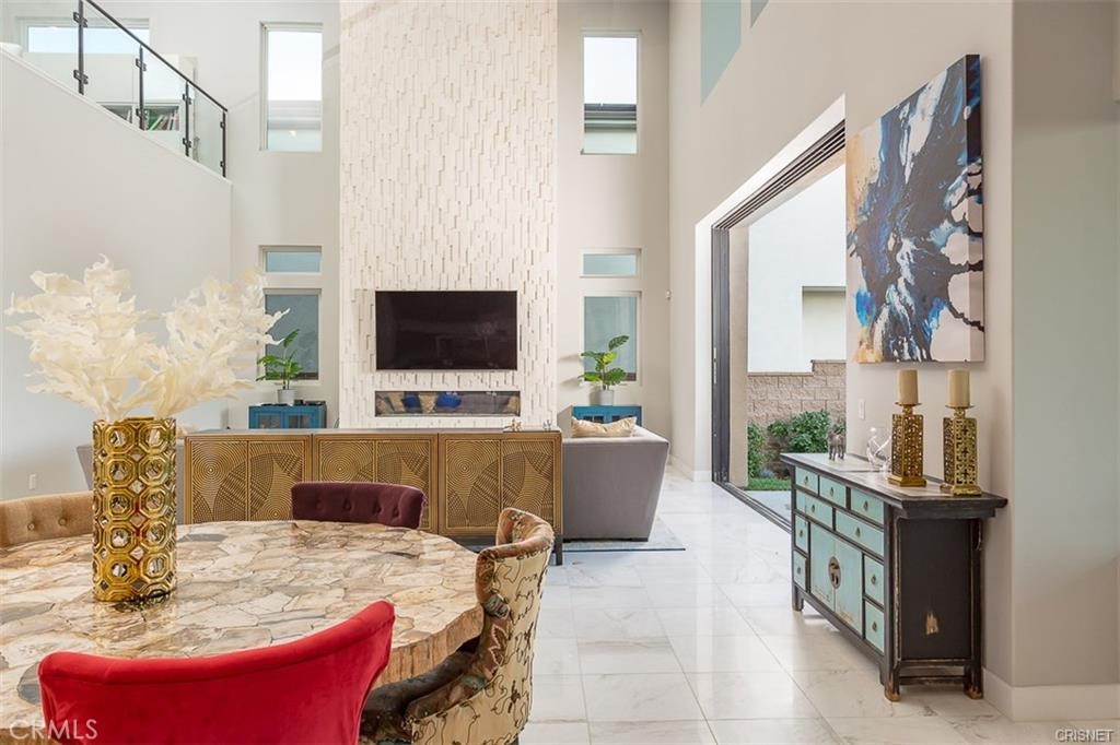 11527 North Darcy Porter Ranch Porter Ranch, CA 91326 - Photo 10 of 32 a living room with furniture a flat screen tv and a chandelier