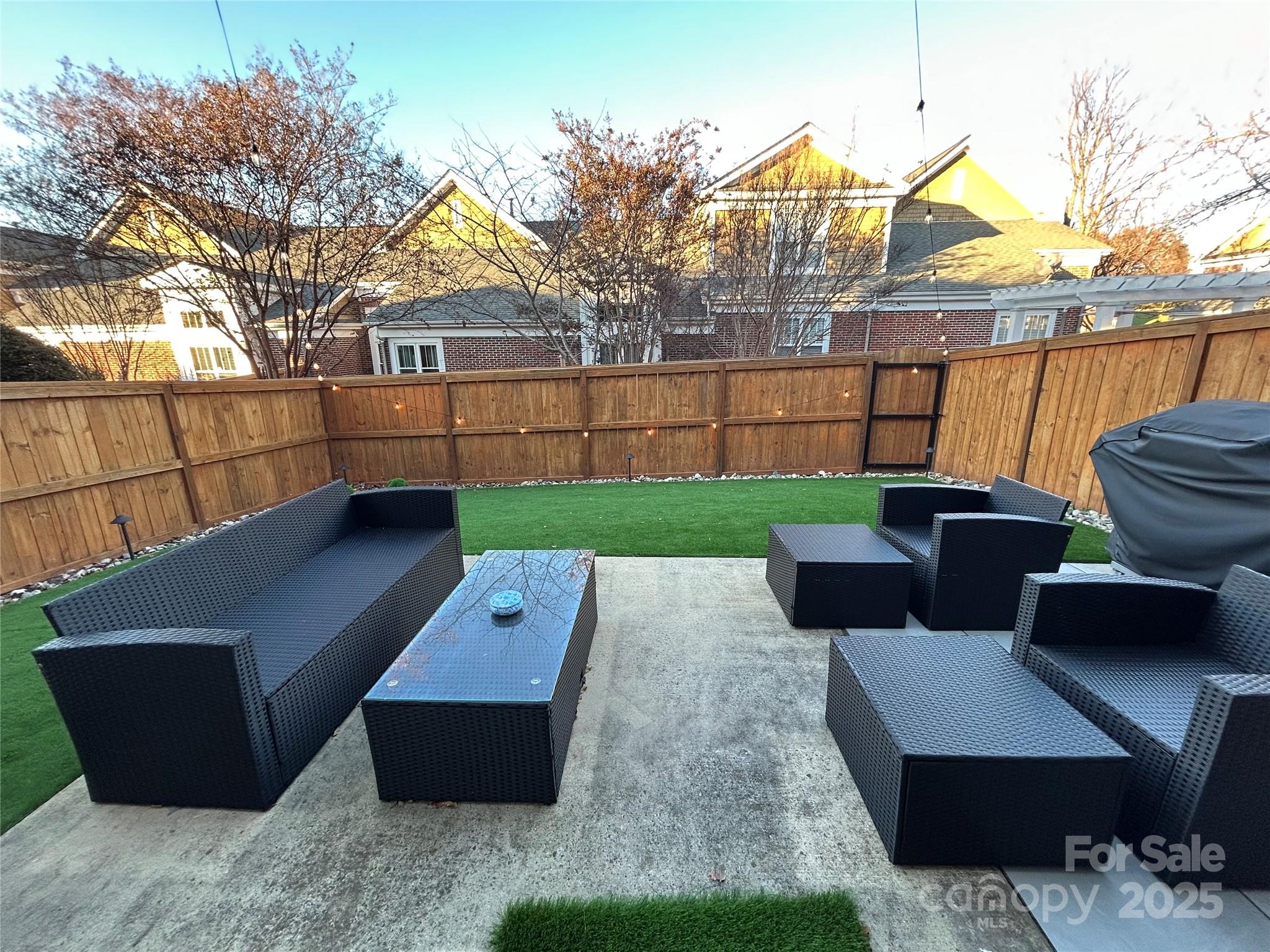 18731 Ramsey Cove Drive, Unit 72 Cornelius, NC 28031 - Photo 19 of 33 a view of a backyard with couches and a fire pit