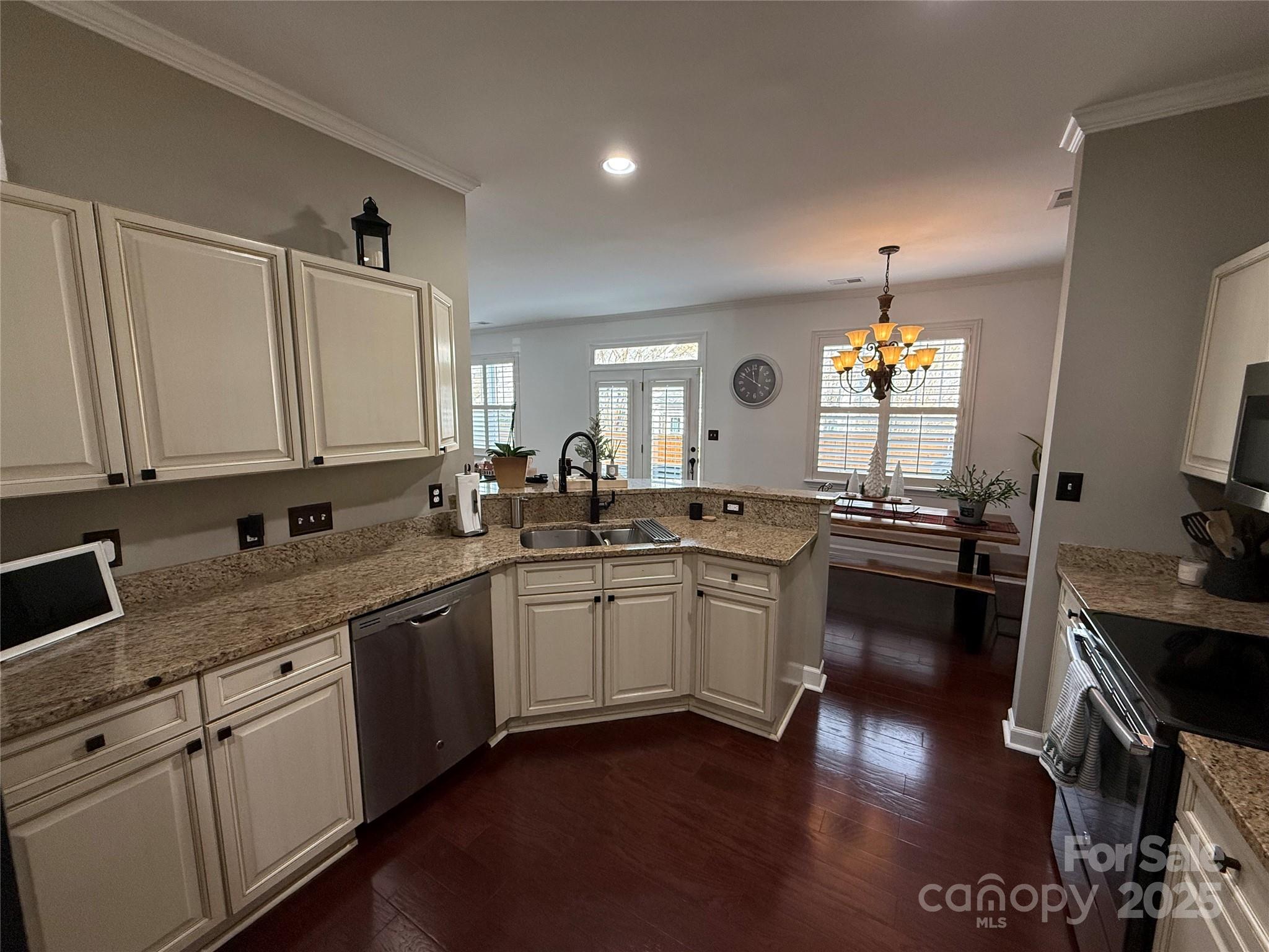 18731 Ramsey Cove Drive, Unit 72 Cornelius, NC 28031 - Photo 25 of 33 a kitchen with a sink cabinets and wooden floor