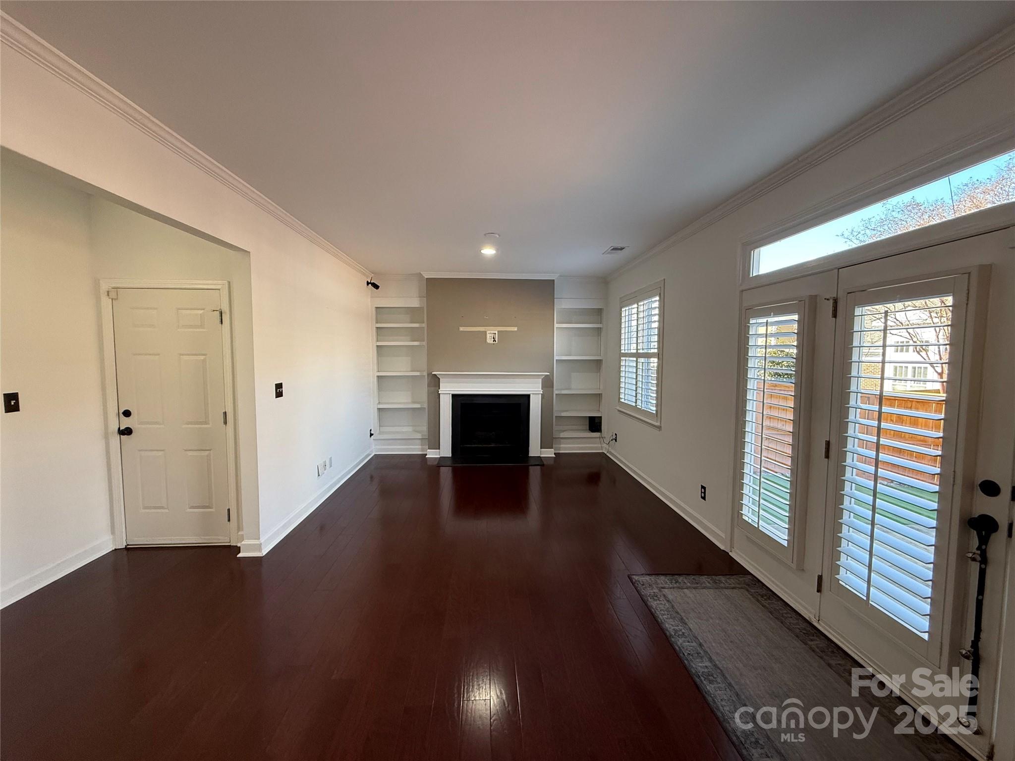 18731 Ramsey Cove Drive, Unit 72 Cornelius, NC 28031 - Photo 4 of 33 wooden floor in an empty room with a fireplace