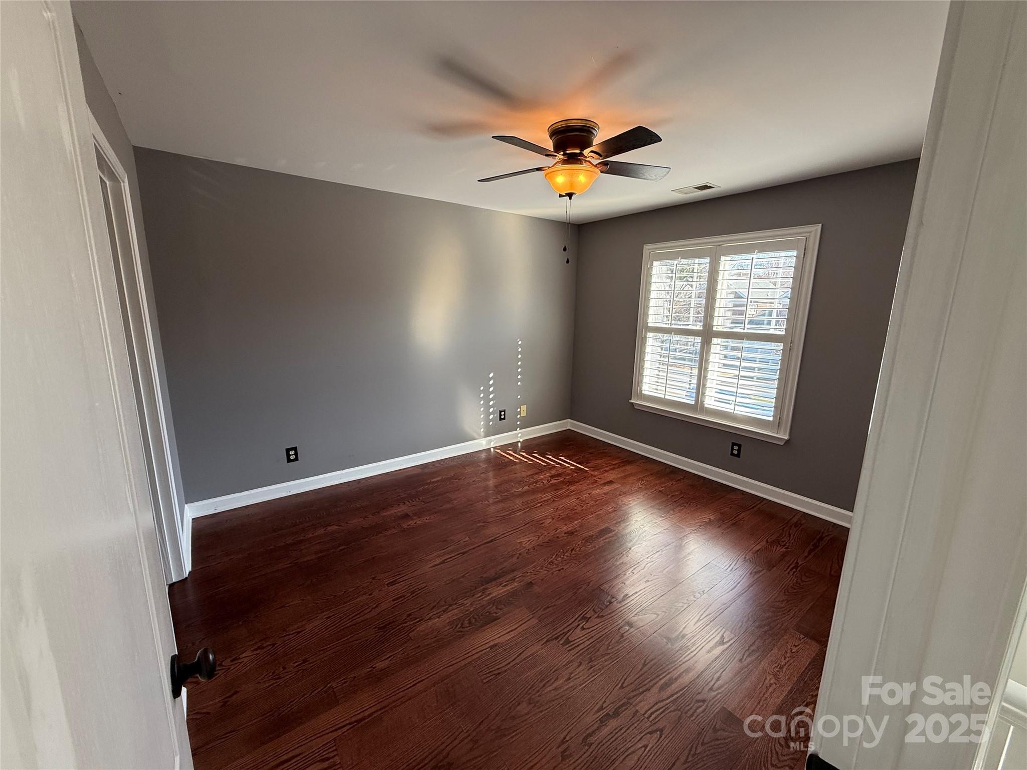 18731 Ramsey Cove Drive, Unit 72 Cornelius, NC 28031 - Photo 7 of 33 an empty room with wooden floor and windows