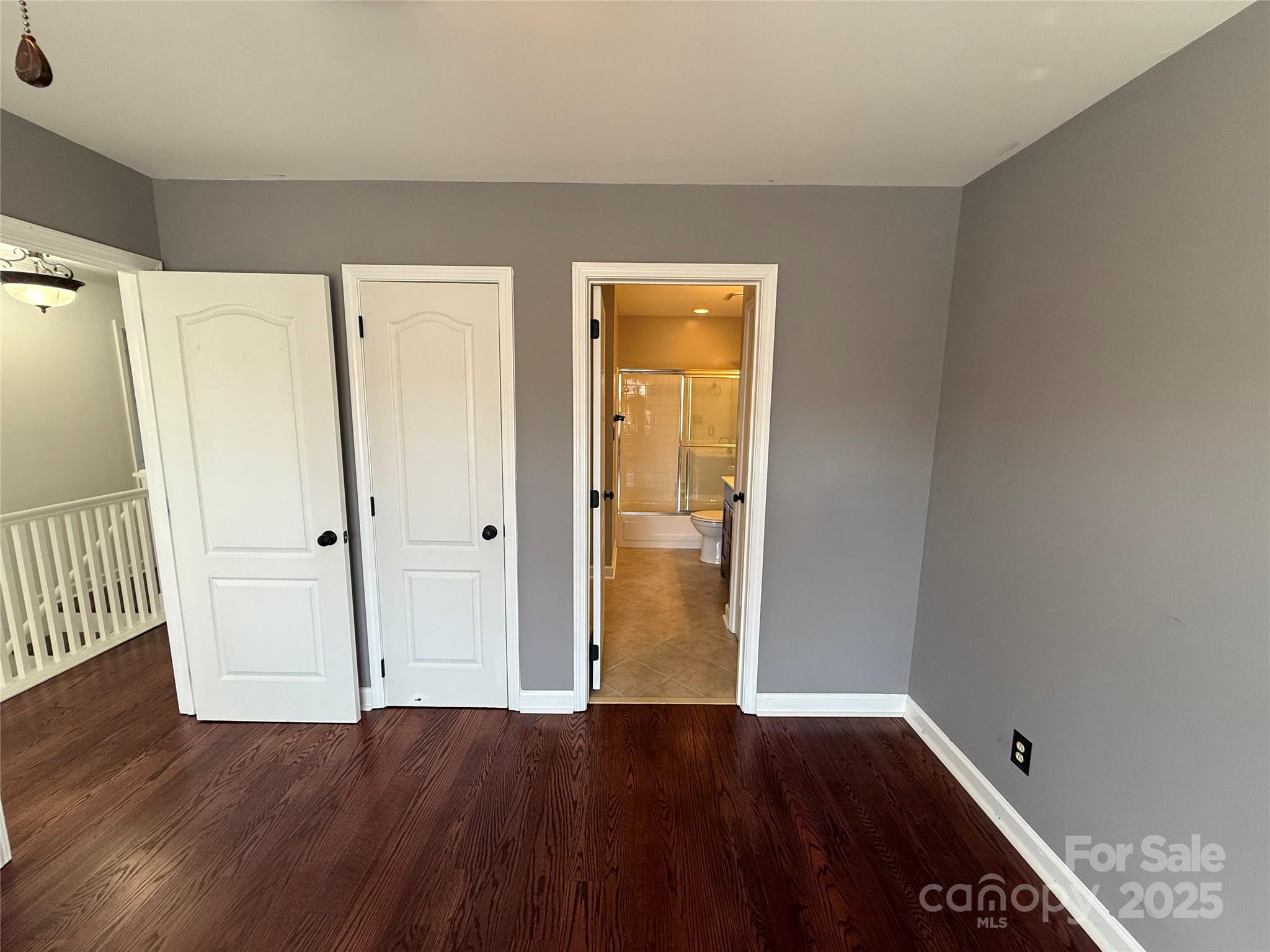 18731 Ramsey Cove Drive, Unit 72 Cornelius, NC 28031 - Photo 8 of 33 a view of an empty room with wooden floor and a window