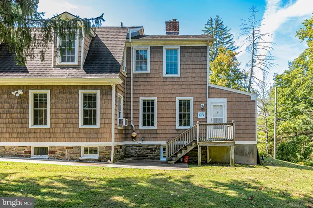 a view of a house with a yard patio and swimming pool