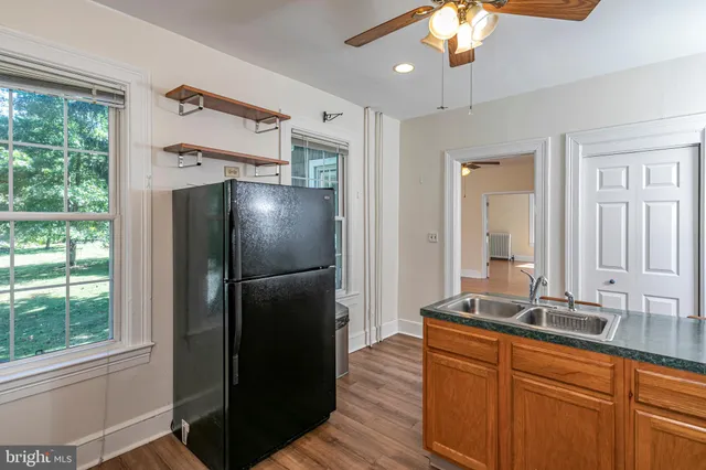 a kitchen with stainless steel appliances granite countertop a refrigerator and a sink
