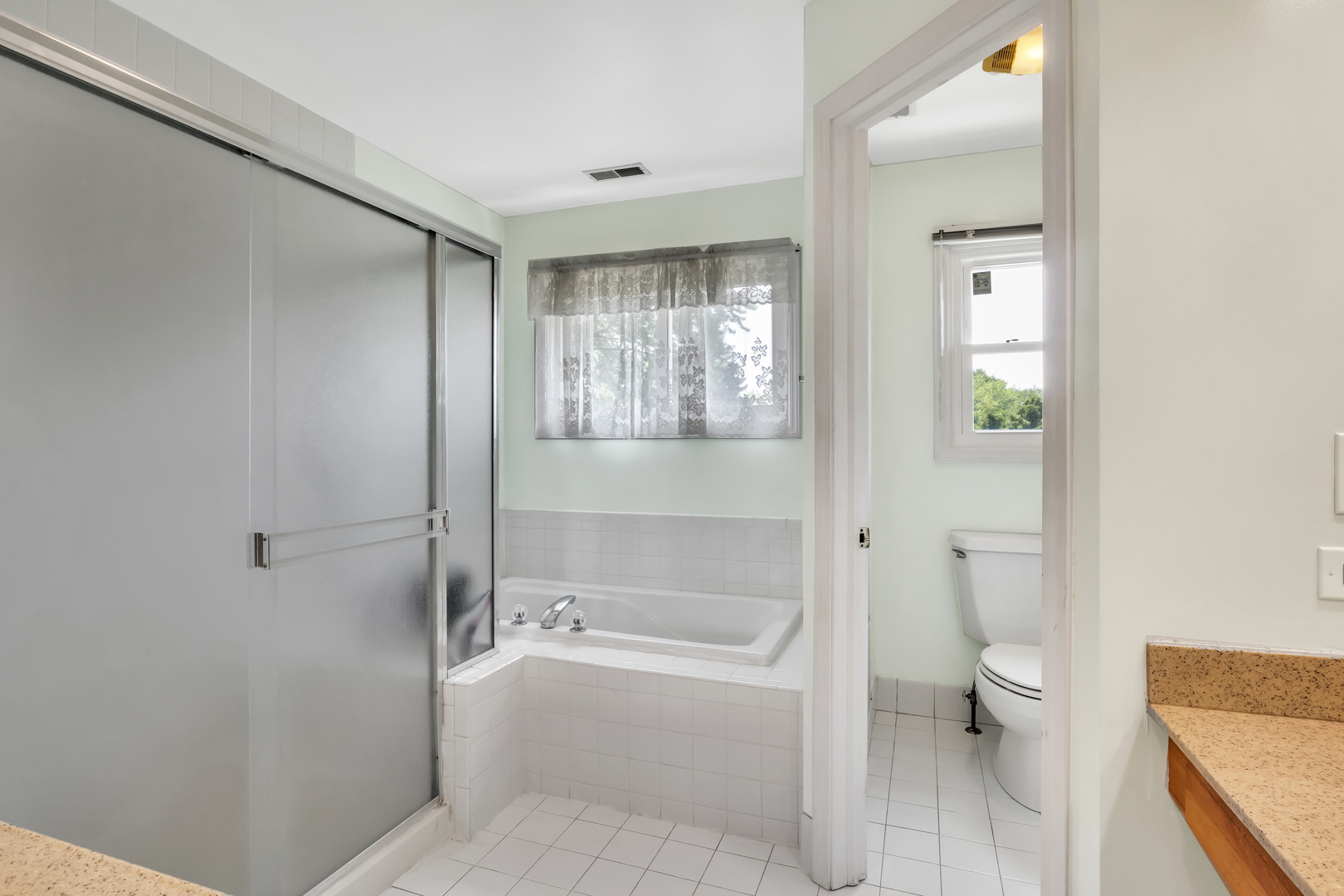 700 Greenview Lane Wheeling, IL 60090 - Photo 11 of 26 a bathroom with a granite countertop toilet a sink and bathtub